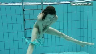 Podvodkova swimming in blue bikini in the pool