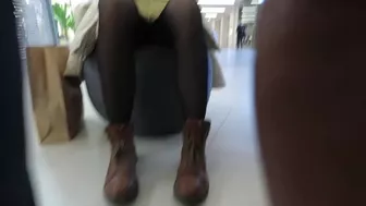 A girl walks in a short skirt without panties in a shopping mall